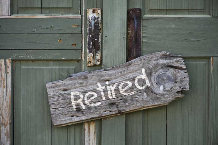Wooden Retired sign on an old green door