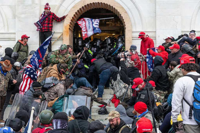 Crowd storming a building entrance with flags and signs