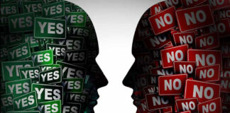 Silhouettes filled with YES and NO signs facing each other