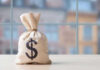 Money bag with dollar sign on table