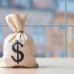 401K Safety Net SHATTERED — Experts Panicking Money bag with dollar sign on table