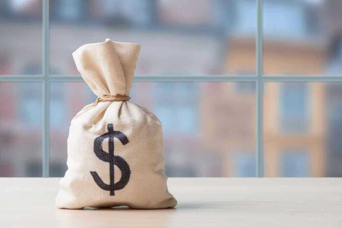 2425646037 Money bag with dollar sign on table