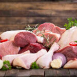 Beef Lovers Beware: The Scary Health Risks Assorted raw meat with vegetables on wooden table