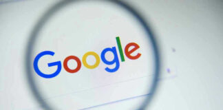 Google logo viewed through a magnifying glass