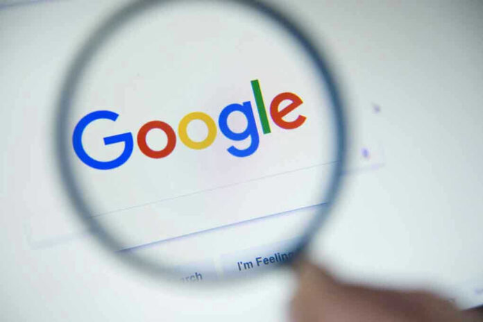 Google logo viewed through a magnifying glass