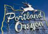Neon sign reading Portland Oregon with a leaping deer against a blue sky