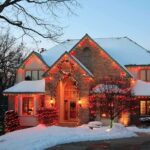 Holiday Budget Nightmare: Are Families Ready? A beautifully decorated house with Christmas lights in a snowy setting