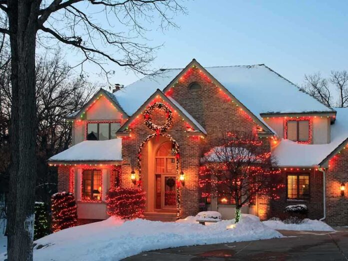A beautifully decorated house with Christmas lights in a snowy setting
