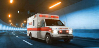 Ambulance driving through a brightly lit tunnel