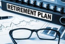 Close up of a retirement plan binder with glasses and financial charts
