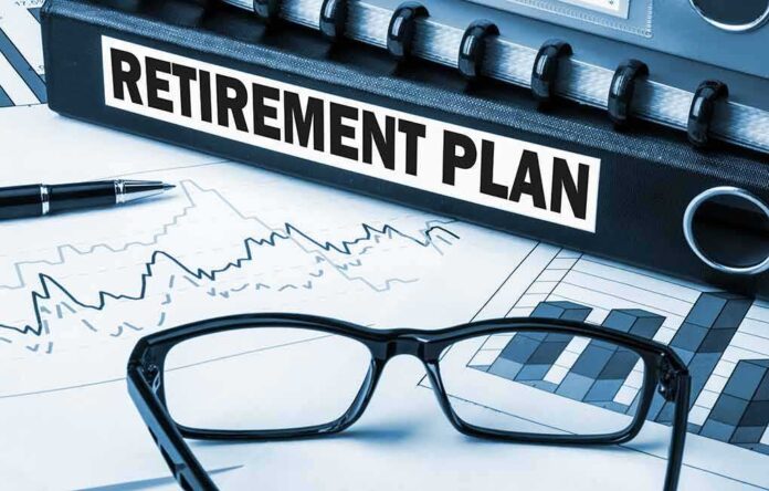 Close up of a retirement plan binder with glasses and financial charts