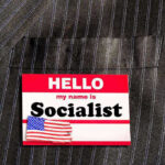 Socialist TAKEOVER Stuns Major WEST COAST City Hello my name is Socialist name tag on suit.