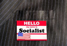 Socialist TAKEOVER Stuns Major WEST COAST City Hello my name is Socialist name tag on suit.