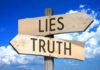 SHOCKING Twist — ICE Lie Unraveled Signs pointing to Lies and Truth against sky.