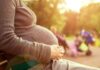 Highway Birth Triggers Hospital Staff FIRINGS Pregnant woman sitting on a bench in a park during sunset