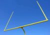 Shocking ACCUSATIONS — Coach Turned FUGITIVE Yellow football goalpost against a clear blue sky