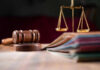 Judges gavel, scales of justice, and legal documents.
