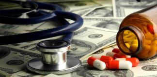 Stethoscope and prescription pills on a background of dollar bills