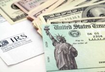 A tax refund check from the IRS alongside various denominations of cash