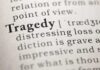 Close-up of a dictionary page showing the definition of 'tragedy'