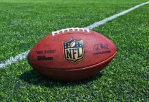 UNEXPECTED Kelce Move Stuns Swift Fans An NFL football resting on a green grass field
