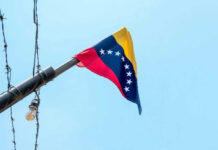 Venezuelan flag flying on a pole.