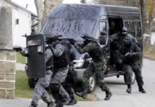SWAT team members in tactical gear responding to a situation