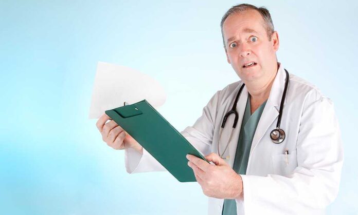 shutterstock_27227845.jpg A doctor in a white coat looking surprised while holding a clipboard