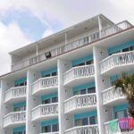 Resort Nightmare: Indecent Act Caught on Camera Exterior view of a beachfront hotel with balconies and colorful towels hanging