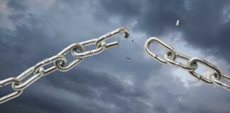 A broken metal chain against a stormy sky