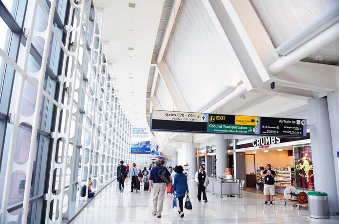 shutterstock_99344561.jpg Interior of an airport terminal with travelers and signage
