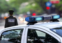 Police car and officer on a city street.