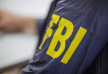 Iranian Hackers Breach FBI Director’s Email FBI jacket with yellow lettering.