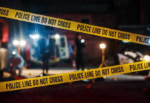 Yellow police tape in front of crime scene.