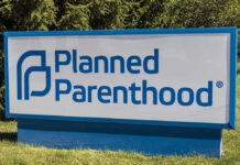 Planned Parenthood sign on a grassy lawn.