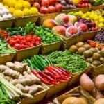 A vibrant display of assorted fruits and vegetables in baskets at a market