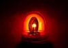 Red emergency light illuminated against a dark background