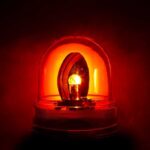 Red emergency light illuminated against a dark background