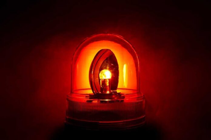 Red emergency light illuminated against a dark background