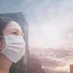 Ebola’s ‘Perfect Storm’—Are We Ready? Person wearing a mask in a cityscape background.