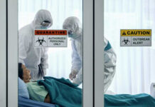 Ebola ALERT: Border Breach Sparks Global Fears Healthcare workers in protective gear in quarantine room.