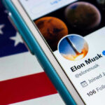 Trump’s China Gambit: Musk & CEOs in Play? Smartphone showing a Twitter profile, American flag background.