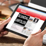 NYT Column Slammed as ‘Modern-Day Blood Libel’ Person reading news headline Scandal Unfolds on tablet