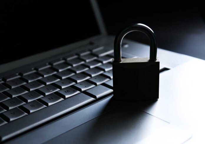 Laptop,And,Padlock.,Concept,Of,Computer,Security./computer,Security A padlock resting on a laptop keyboard in a dimly lit environment
