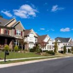 Property Taxes ERASED? Cities Panic A row of modern suburban houses under a clear blue sky