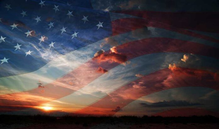 shutterstock_197253860.jpg A sunset with an overlay of the American flag and dramatic clouds