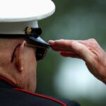 Combat Vet DEMANDS Iran Strategy Shift A veteran in military uniform saluting with a hand raised