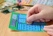 Lottery SHOCKER: Karma Pays Big! A person scratching off a bingo lottery ticket with a coin