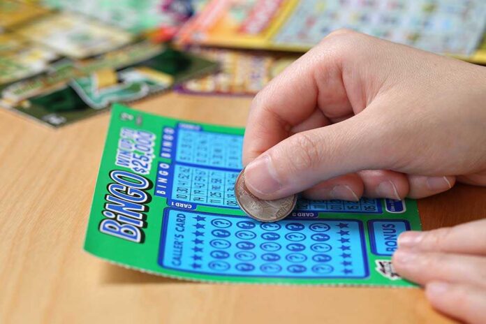 Coquitlam,Bc,Canada,-,June,15,,2014,:,Woman,Scratching A person scratching off a bingo lottery ticket with a coin