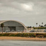Third Marine Suicide—Then This? Aircraft hangar with helicopters near the beach.